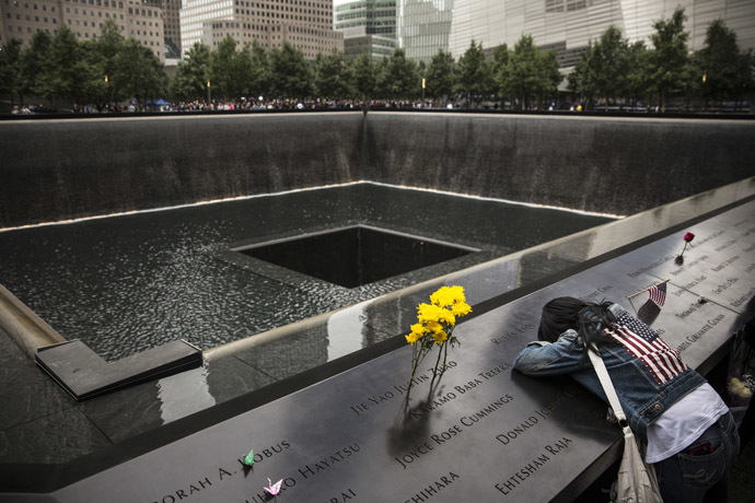A relative mourns a victim of the 9/11 terrorist attack during the memorial observances held at the site of the World Trade Center in New York, September 11, 2014. AFP Photo/Andrew Burton