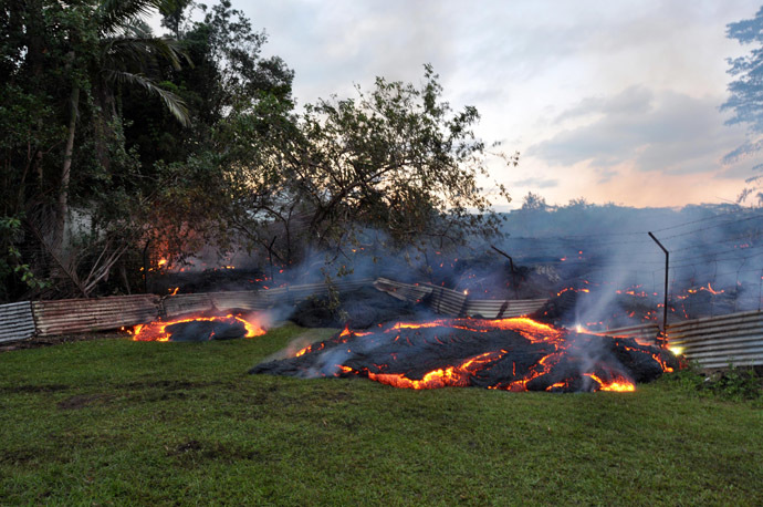 This October 28, 2014 image provided by the US Geological Survey(USGS) shows the lava that has pushed through a fence marking a property boundary above PÄhoa in Hawaii. (AFP Photo)