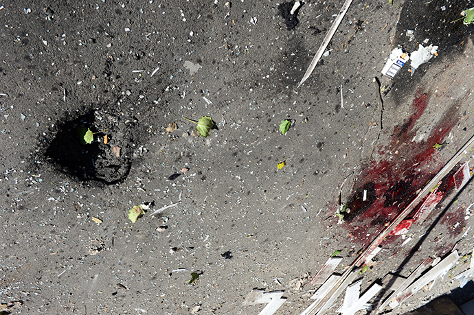 A photo taken on October 3, 2014 shows the scene of a rocket attack which killed a Swiss International Committee of the Red Cross (ICRC) worker outside the International Committee of the Red Cross office in Donetsk the day before. Shelling in the center of the main rebel-held city in Ukraine's east killed a Swiss Red Cross worker on October 2, tearing badly at a weakly observed four-week truce meant to defuse Europe's worst crisis in decades (AFP Photo / John Macdougal)