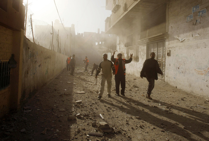 Palestinian rescue workers survey the scene after an Israeli air strike targeted a house in Rafah in the southern Gaza Strip December 31, 2008. (Reuters / Ibraheem Abu Mustafa)