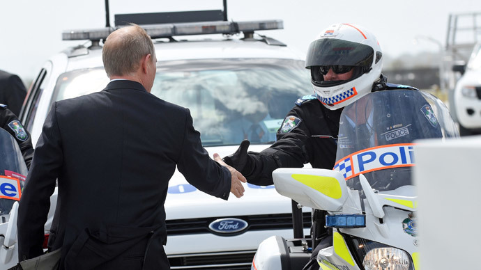 Russiaâs President Vladimir Putin (L) shaking hands with members of his motorcycle escort at the airport in Brisbane as he leaves the G20 Summit.(AFP Photo / Steve Holland)