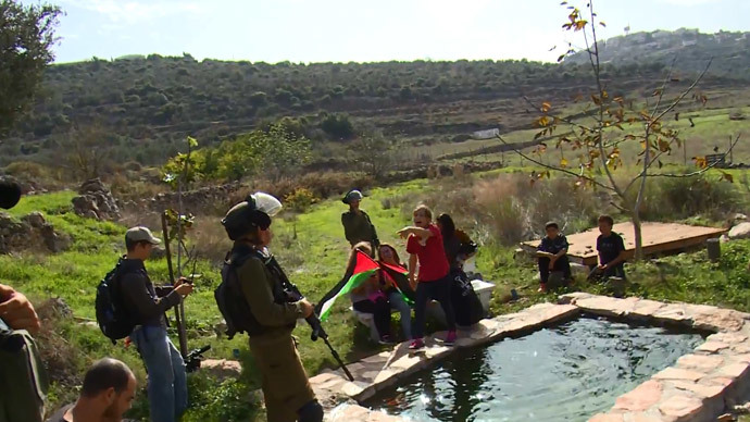 8-year-old Jana Tamimi confronts Israeli soldiers near her home villageâNabi Saleh in the West Bank.(A screenshot from a video by YouTube user David Reeb)