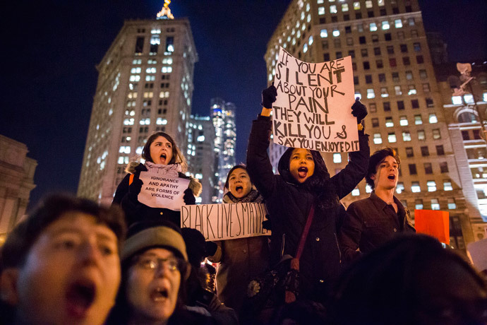 Protesters, demanding justice for Eric Garner, hold placards while shouting slogans in Foley Square, New York December 4, 2014. (Reuters / Elizabeth Shafiroff)
