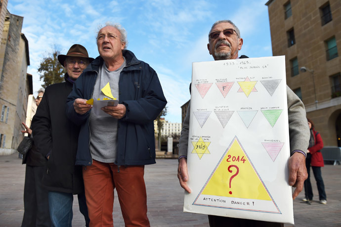 A demonstrator holds a sign in front of the City Hall of Marseille, southern France, on December 3, 2014, during a demonstration against a "security badge" distributed to homeless people in Marseille. (AFP Photo / Anne-Christine Poujoulat)