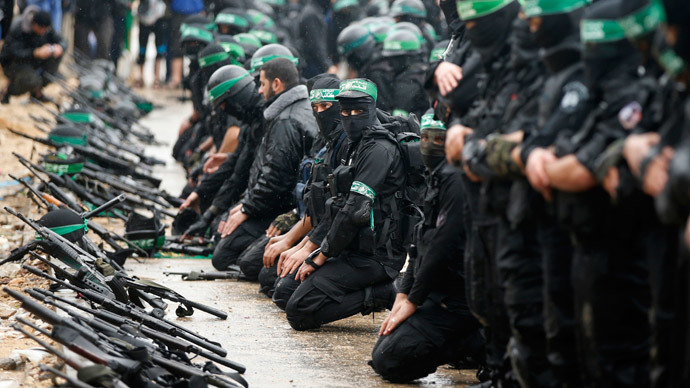 Palestinian members of al-Qassam Brigades, the armed wing of the Hamas movement, pray before a military parade marking the 27th anniversary of Hamas' founding, in Gaza City December 14, 2014. (Reuters / Mohammed Salem)
