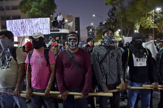 Protesters march demanding justice and clarification of the disappearance of 43 students from Ayotzinapa, on December 6, 2014 in Mexico City. (AFP Photo/Yuri Cortez)