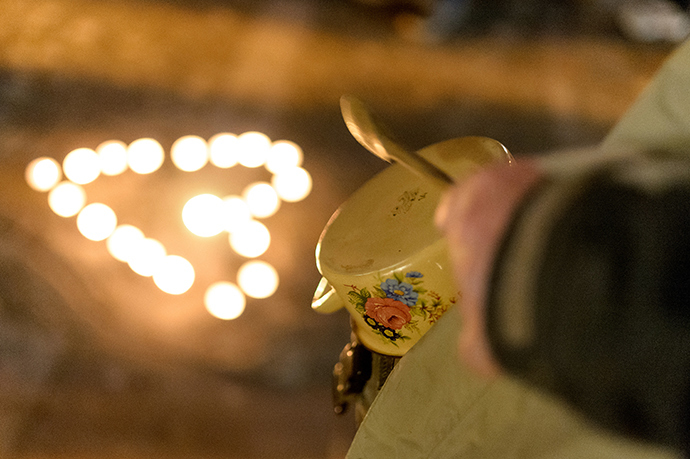 A member of the "Trans-Universal Zombie Church of the Blissful Ringing" hits a pot with a spoon during their weekly "mass" in front of the Slovenian parliament, the "sanctuary of corruption", in Ljubljana, Slovenia on November 19, 2014 (AFP Photo / Jure Makovec)