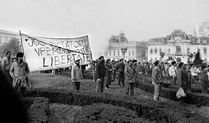 File photo of the first anti-communist demonstrators gathering in front of the Central Committee of the Romanian Communist Party headquarters after Ceausescu fled the building in a helicopter in Bucharest December 22, 1989. (Reuters/Lucian Crisan)