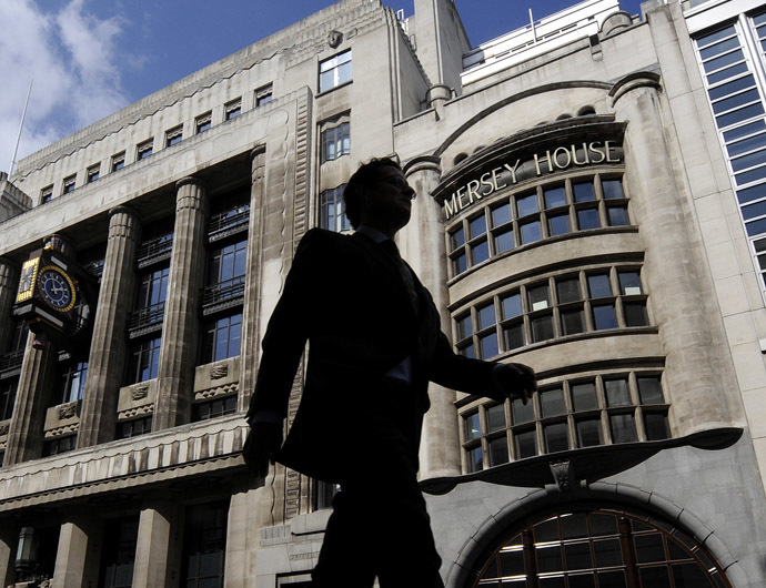 A pedestrian passes offices of Goldman Sachs in London (Reuters/Toby Melville)
