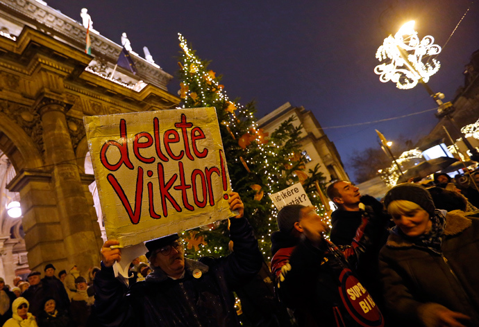 man holds a placard during an anti-government protest called by civil groups in Budapest January 2, 2015 (Reuters / Laszlo Balogh)