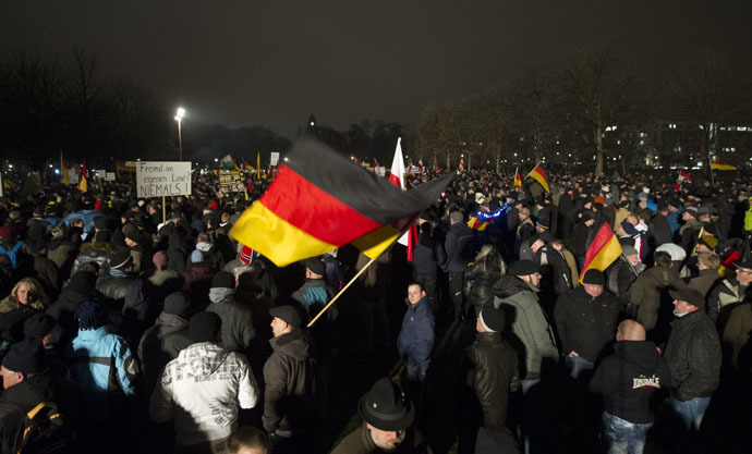 Demonstrators wave with German national flags during a rally by a mounting anti-immigration movement called Pegida on January 5, 2015 in Dresden, eastern Germany. (AFP Photo)