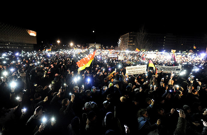 Sympathizers of German anti-immigration movement PEGIDA (Patriotic Europeans Against the Islamisation of the Occident) attend their twelfth march in Dresden, eastern Germany on January 12, 2015. (AFP Photo / Robert Michael)