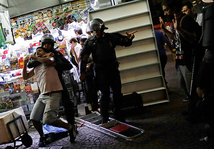 Riot police detain a demonstrator during a protest against fare hikes for city buses, subway and trains in Sao Paulo January 16, 2015 (Reuters / Nacho Doce)
