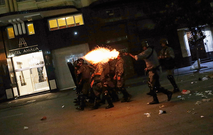 Riot police fire tear gas at demonstrators during a protest against fare hikes for city buses, subways and trains in Sao Paulo January 16, 2015 (Reuters / Nacho Doce)