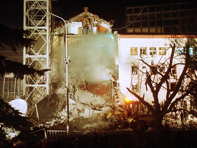 Work crews use a digger at the destroyed part of the Radio-Television Serbia building after a NATO air strike over Yugoslav capital early April 23, 1999. (Reuters)