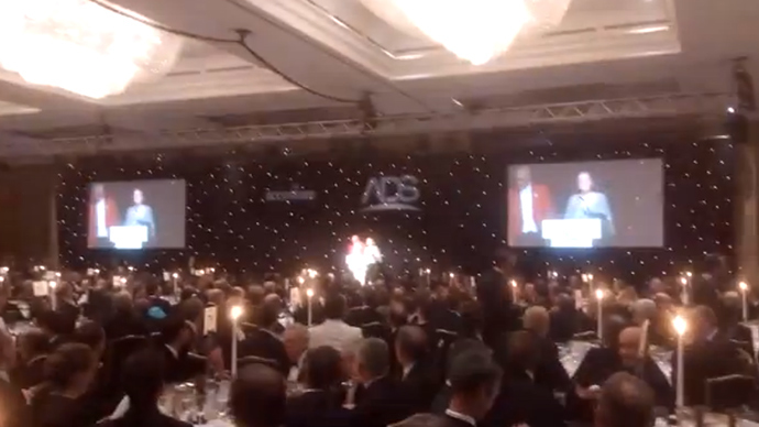 Pregnant activist crashes glitzy arms industry dinner, urges guests ‘consider career change’