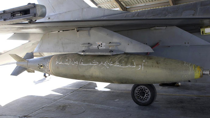 A bomb with Koranic verses is pictured on a Royal Jordanian Air Force plane at an air base before it's launch to strike the Islamic state in the Syrian city of Raqqa February 5, 2015. (Reuters/Petra News Agency)
