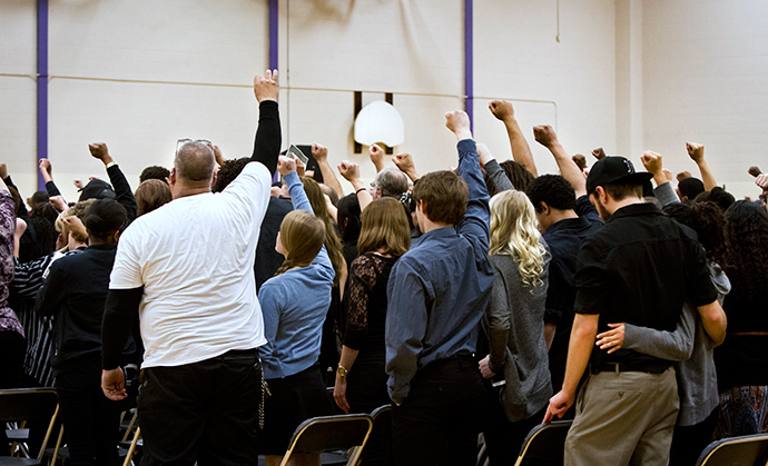 Supporters raise their hands in support during the funeral for Tony Robinson, Jr. at Madison East High School in Madison, Wisconsin, March 14, 2015 (Reuters / Ben Brewer)