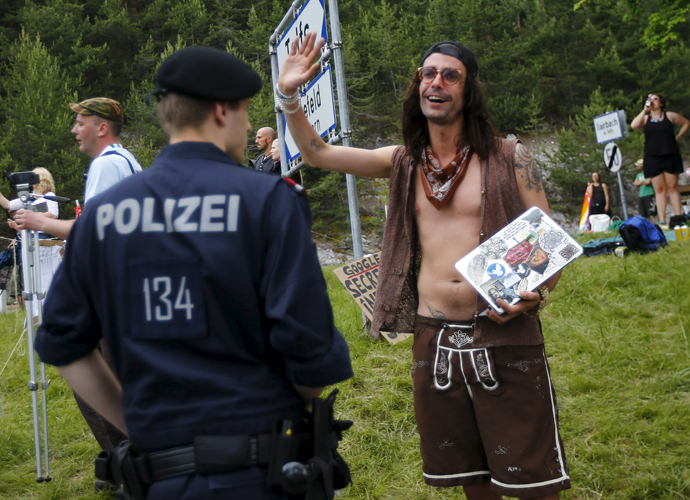 Austrian police officers stand guard at a street check point before the Bilderberg meetings at Interalpen Hotel in the Austrian village of Buchen, June 12, 2015. (Reuters / Leonhard Foeger)
