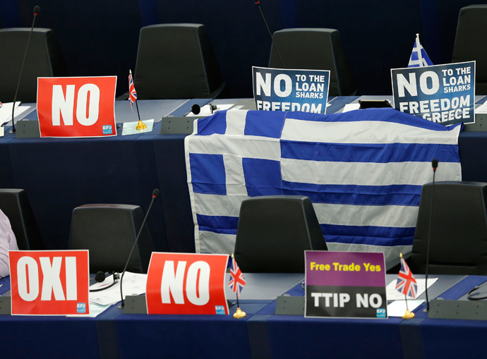 Posters with the word "No" (Oxi) and a Greek flag are seen on the desks of Members of the European Parliament during a debate on Greece at the European Parliament in Strasbourg, France, July 8, 2015. (Reuters / Vincent Kessler)