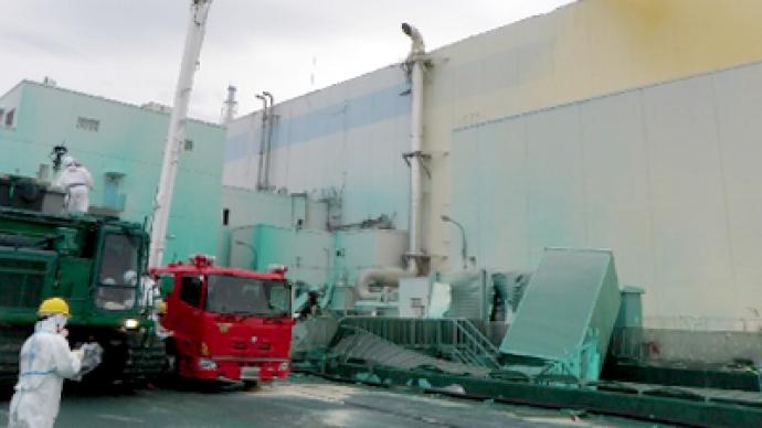 Fukushima operator says “sorry” as workers erect protective cap