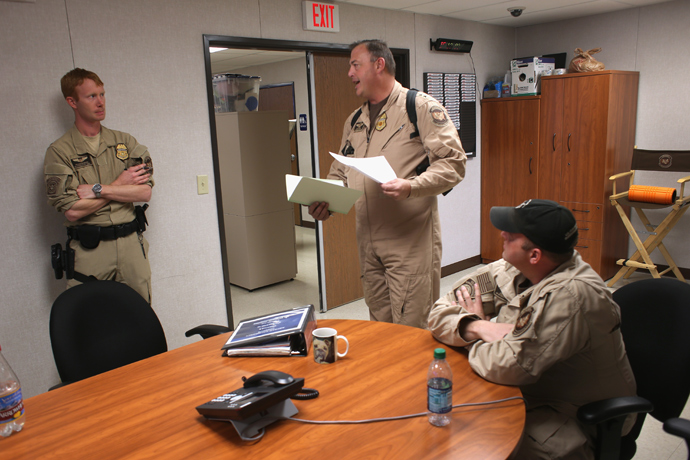 Staff from the U.S. Air and Marine discuss sequestration furloughs before launching Predator drone surveillance flights near the Mexican border on March 7, 2013 from Fort Huachuca in Sierra Vista, Arizona (John Moore / Getty Images / AFP)