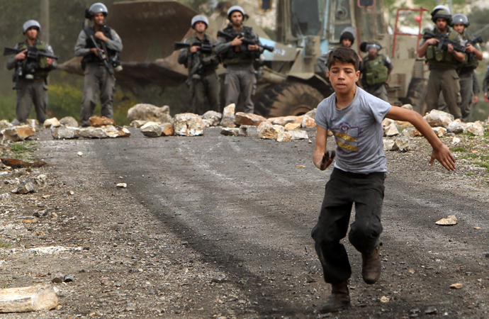 A Palestinian protester runs away from Israeli border guards during clashes following a protest against the expropriation of Palestinian land by Israel on March 8, 2013, in the village of Kafr Qaddum, near the occupied West Bank city of Nablus (AFP Photo / Jaafar Ashtiyeh)