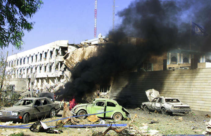 An August 19, 2003 file photo shows a car burning outside the United Nations headquarters at the Canal Hotel in eastern Baghdad after a huge explosion rocked the building leaving several people dead (AFP Photo / Sabah Arar)