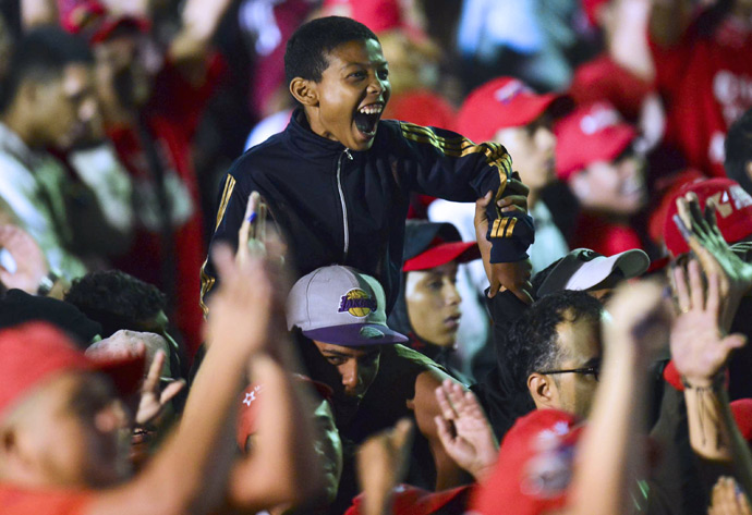 Supporters of Venezuelan acting President Nicolas Maduro celebrate after knowing the election results in Caracas on April 14, 2013 (Reuters / Luis Acosta)