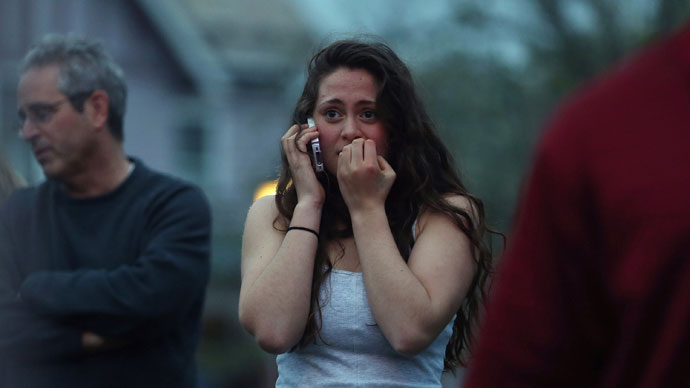 Resident Rosie Meyer (C), who said she heard gunshots, reacts while watching police respond on April 19, 2013 in Watertow.(AFP Photo / Mario Tama)