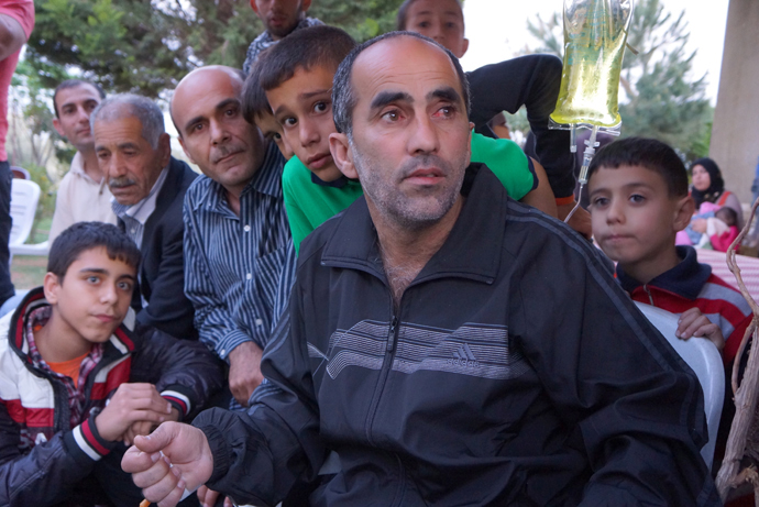 Truck driver Hussein Kemel Jafar was held captive 24 days. His eyes are red from the beating and torture. His family is proud that they too had captured five hostages, including the FSA militant. On the right - his youngest son, Nasrallah. If the Syrian war comes to Lebanon, people will be killed just because of their name. (Photo by Nadezhda Kevorkova)