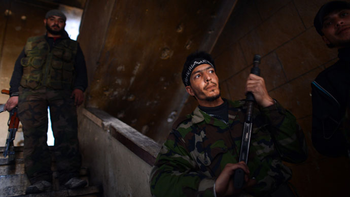 Syrian rebels take position inside a building in the Saif al-Dawla district of the northern Syrian city of Aleppo on April 5, 2013.(AFP Photo / Dimitar Dilkoff)