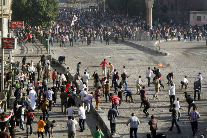 Anti-government protesters throw stones at Muslim Brotherhood members during clashes near Cairo's Tahrir Square April 19, 2013.(Reuters / Mohamed Abd El Ghany)