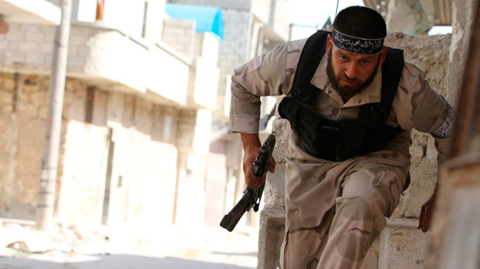 A Free Syrian Army fighter runs for cover near Nairab military airport in Aleppo June 12, 2013.(Reuters / Hamid Khatib )