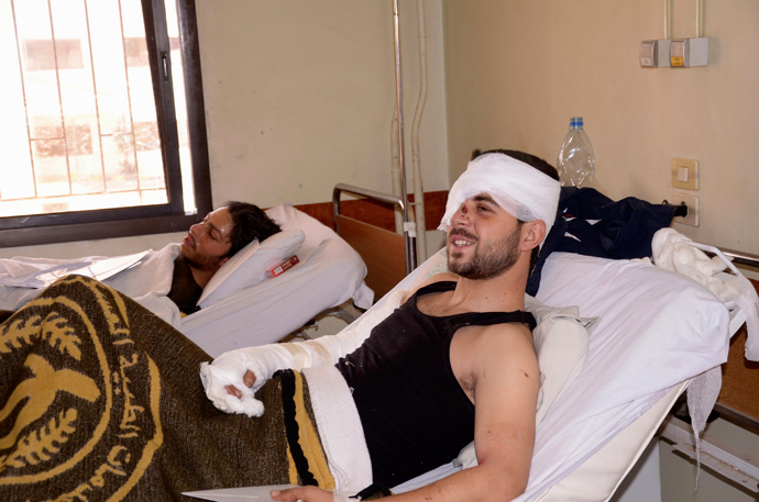 A man injured by chemical weapons smiles during the visit of Syrian government officials at a hospital in Aleppo, March 21, 2013 (Reuters / George Ourfalian)