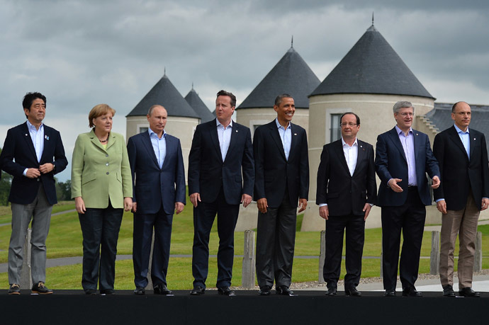 G8 leaders (L-R) Japan's Prime Minister Shinzo Abe, Germany's Chancellor Angela Merkel, Russia's President Vladimir Putin, Britain's Prime Minister David Cameron, US President Barack Obama, France's President Francois Hollande, Canada's Prime Minister Stephen Harper and Italy's Prime Minister Enrico Letta stand on the podium for the family photograph on the second day of the G8 summit at the Lough Erne resort near Enniskillen in Northern Ireland on June 18, 2013. (AFP Photo/Ben Stansall)