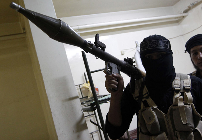 A Free Syrian Army fighter poses for a picture as he holds an RPG launcher in Raqqa province, eastern Syria September 4, 2013. (Reuters/Nour Fourat)