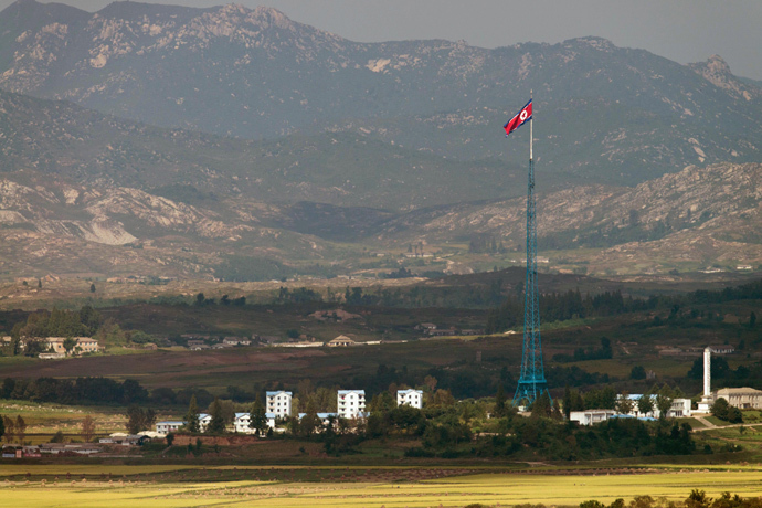 A North Korean flag flutters over North Korea's village of Gijungdong as seen from an observatory point in Paju near the Demilitarized Zone (DMZ) dividing the two Koreas (AFP Photo / Kim Doo-Ho)