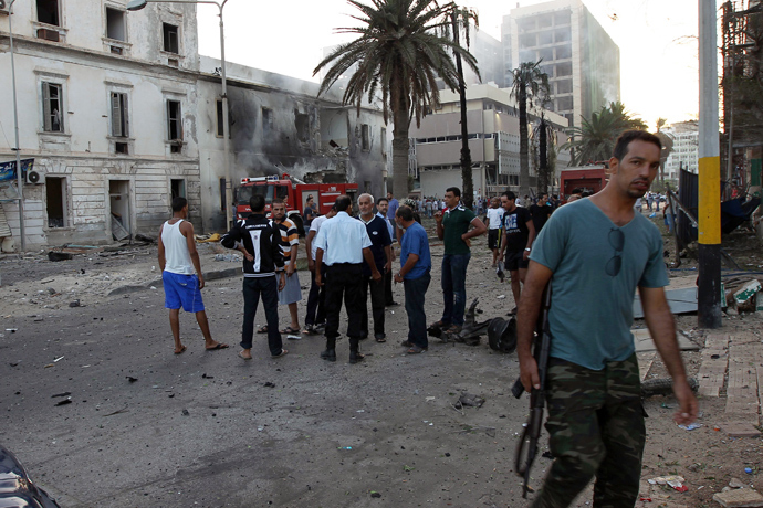 Libyans gather outside a foreign ministry building that was damaged by a powerful blast on September 11, 2013 in the eastern Libyan city of Benghazi (AFP Photo)
