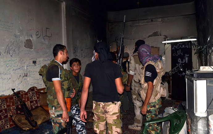 A handout image released by Syrian activists on September 30, 2013, allegedly shows a Syrian rebels meeting in a room in the northeastern city of Deir Ezzor. (AFP Photo / Huthaifa Al-Maaruf)