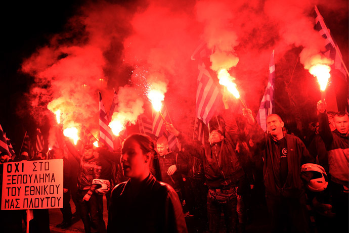Members of the ultra nationalist party Golden Dawn chant the Greek national anthem outside the German embassy in Athens on March 22, 2013. (AFP Photo)