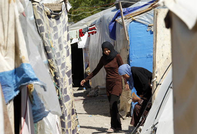 Palestinian refugee women from Syria plays are seen outside their tents at Ain al-Helweh Palestinian refugee camp near the port-city of Sidon, southern Lebanon (Reuters/Ali Hashisho)