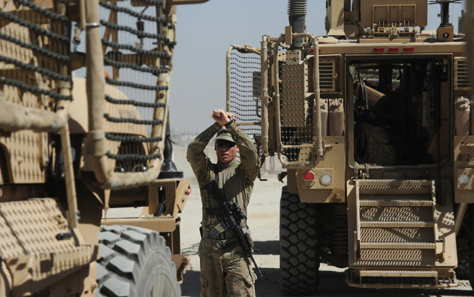 An US soldier from the 10th Mountain Division makes hand signals as Maxxpro Mine Resistant Ambush Protected vechiles prepare to leave on an operation at the Forward Operating Base Ghazni (AFP Photo / Dibyangshu Sarkar)