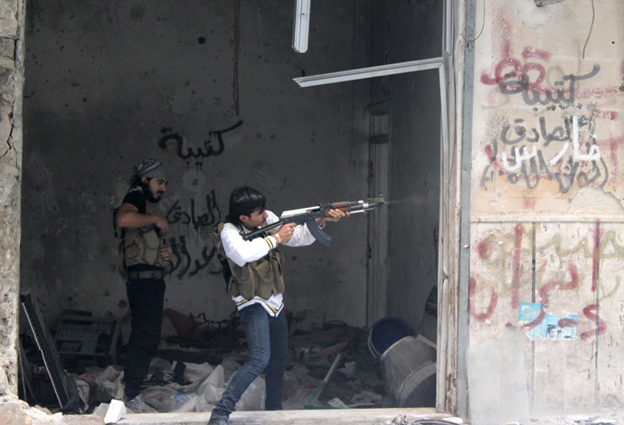 A rebel fighter from the Free Syrian Army fires his weapon during fighting against government forces in the Salah al-Din neighbourhood of the northern Syrian city of Aleppo. (AFP Photo / Mahmud Al-Halabi)