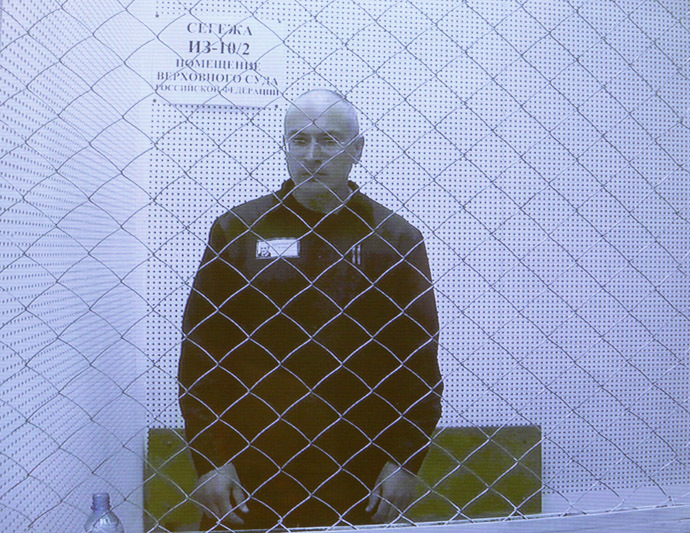 Jailed oil tycoon Mikhail Khodorkovsky is seen on a screen during an appeal for a reduced sentence at Russia's Supreme Court in Moscow August 6, 2013. (Reuters/Maxim Shemetov)