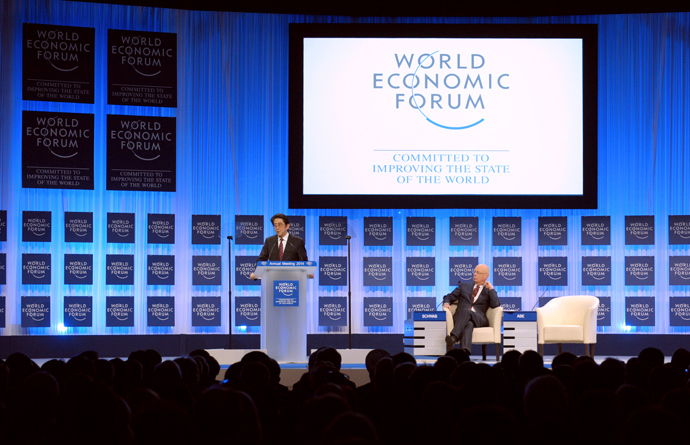 Japanese Prime Minister Shinzo Abe speaks as WEF Executive Chairman Klaus Schwab listens during the opening of the plenary session at the World Economic Forum in Davos on January 22, 2014. (AFP Photo / Eric Piermont)