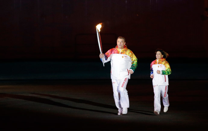 Former hockey player Vladislav Tretiak (L) and figure skater Irina Rodnina run to light the Olympic cauldron during the opening ceremony of the 2014 Winter Olympics in Sochi February 7, 2014 (Reuters / Matt Slocum)