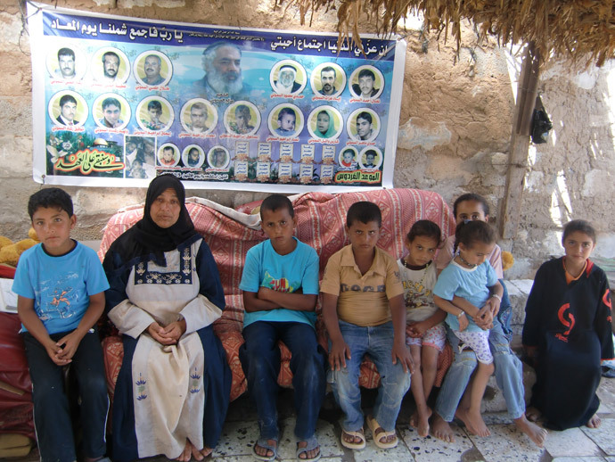 Those of the Samuni family who survived, in front of a placard with their killed relatives. Photo by Nadezhda Kevorkova