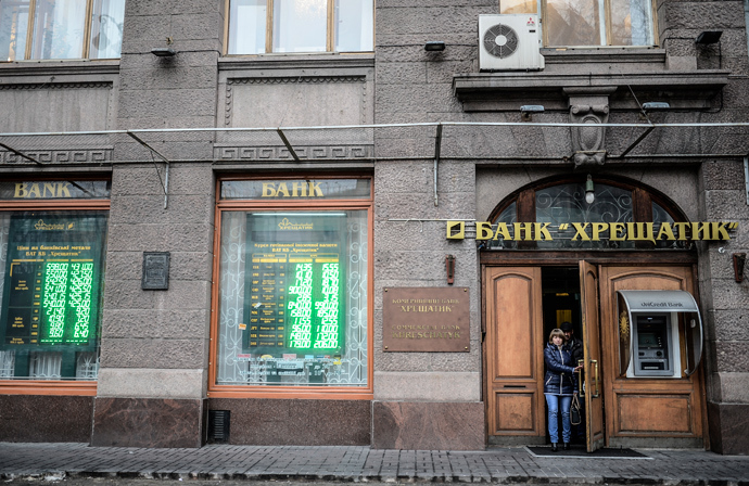 People come out from a bank office in central Kiev on February 28, 2014 (AFP Photo / Bulent Kilic)