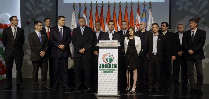 Chairman of the far-right parliamentary JOBBIK (Better) party Gabor Vona (C) reacts for the result of the parliamentary election with his party members at Budapest Congress Center in Budapest on April 6, 2014. (AFP Photo / Peter Kohalmi)